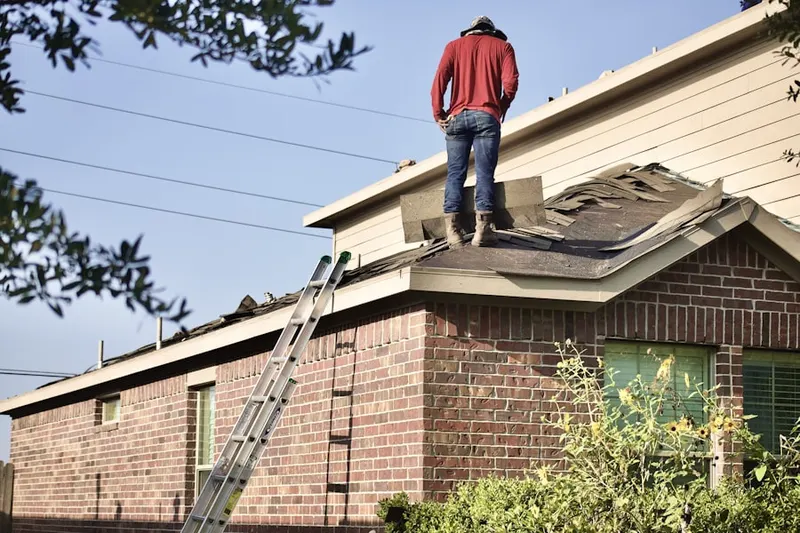 Professional roofer working on a residential roof in Mayville